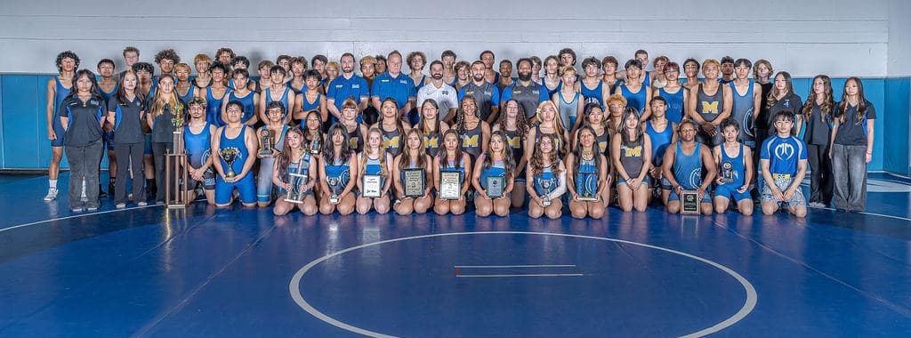 Mira Mesa Wrestling — wrestler in Marauder blue & gold singlet at championship pose
